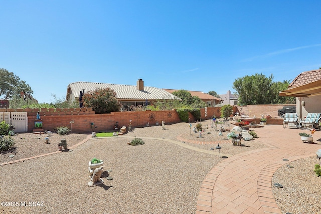 view of yard with a fenced backyard and a patio
