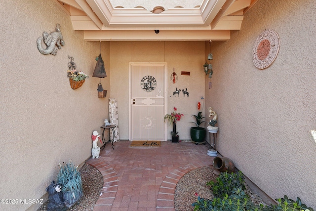 property entrance featuring stucco siding