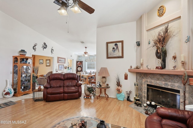 living room featuring wood finished floors, vaulted ceiling, and ceiling fan
