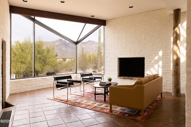 living room with beamed ceiling, plenty of natural light, visible vents, and high vaulted ceiling