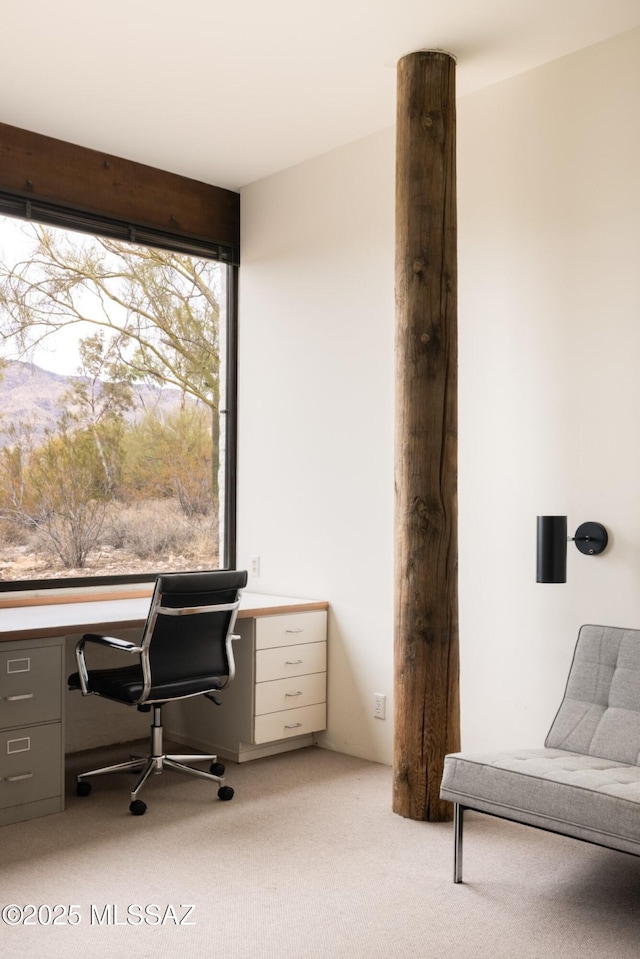office space featuring light carpet and built in study area