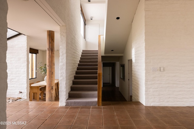 stairs featuring tile patterned floors
