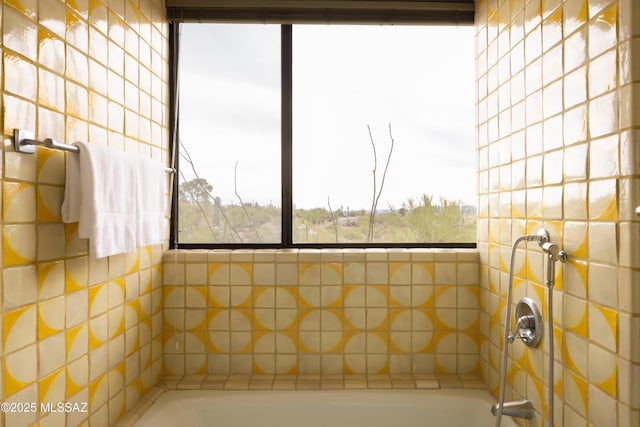 bathroom featuring walk in shower and a bath