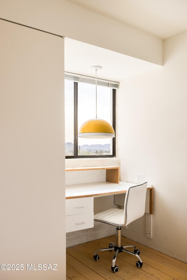 unfurnished office with light wood-style flooring and built in study area