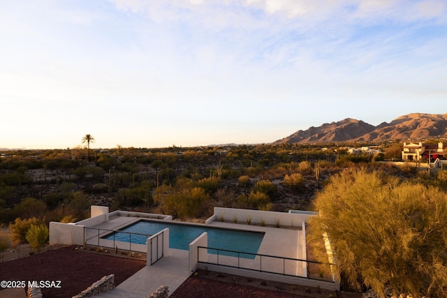 pool featuring a mountain view and fence