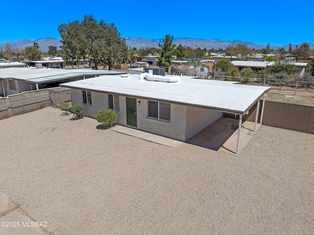 7575 E Apple Tree Dr, Tucson, AZ 85730 - view of front facade featuring a mountain view, a fenced backyard, and stucco siding