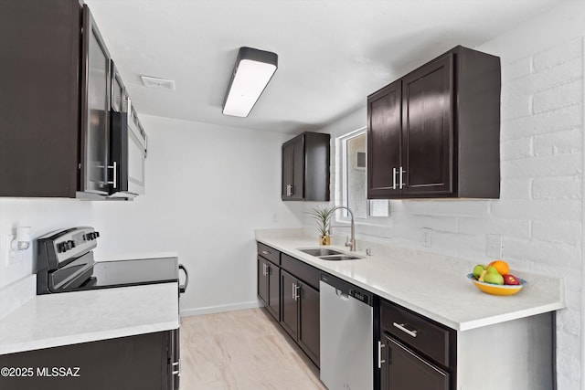 7575 E Apple Tree Dr, Tucson, AZ 85730 - kitchen featuring stainless steel appliances, a sink, light countertops, baseboards, and dark brown cabinetry