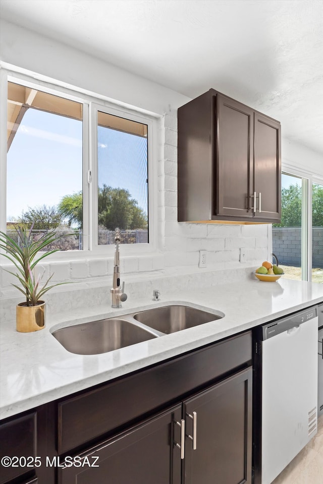 7575 E Apple Tree Dr, Tucson, AZ 85730 - kitchen featuring dishwasher, a sink, light countertops, and dark brown cabinets