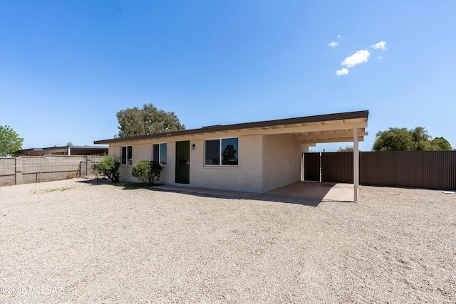 7575 E Apple Tree Dr, Tucson, AZ 85730 - back of property with stucco siding and a patio