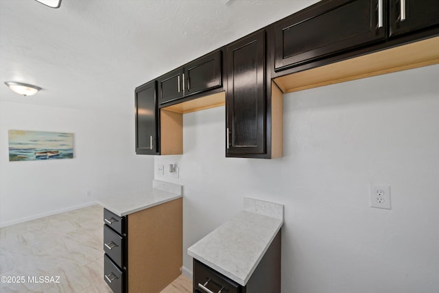 7575 E Apple Tree Dr, Tucson, AZ 85730 - kitchen with light countertops, baseboards, and light marble finish floors