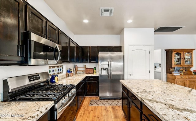 13978 N Big Wash Overlook Pl, Tucson, AZ 85739 - kitchen with stainless steel appliances, light wood-style flooring, light stone countertops, and recessed lighting