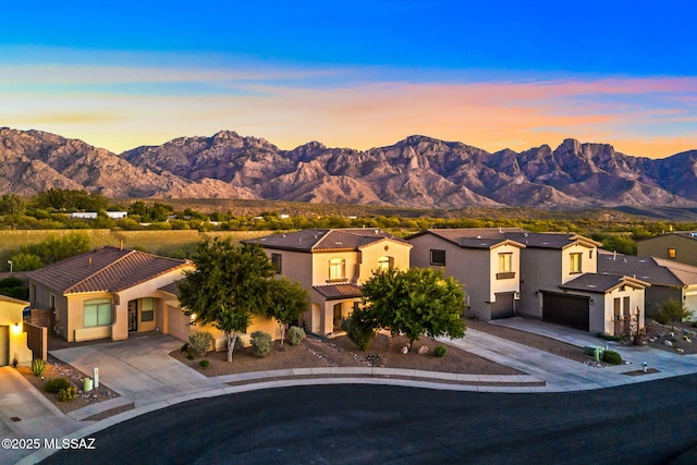 view of front of home featuring a mountain view, driveway, and a garage