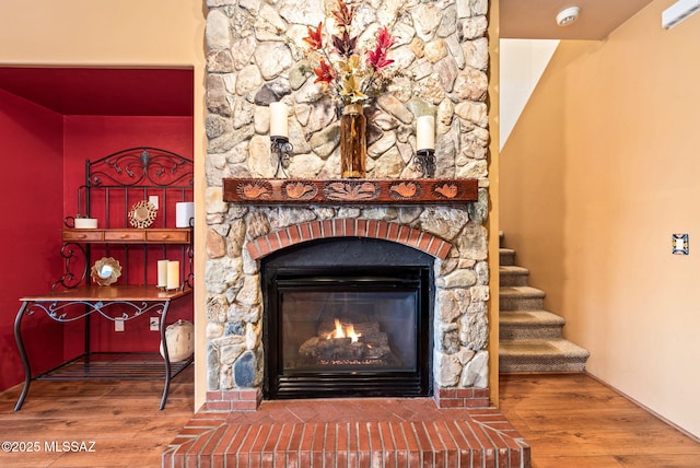 details featuring wood finished floors and a fireplace