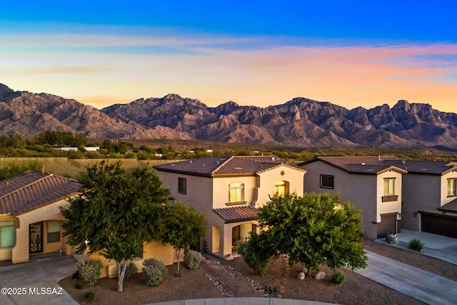 13978 N Big Wash Overlook Pl, Tucson, AZ 85739 - view of front facade with concrete driveway, a mountain view, a tile roof, and stucco siding