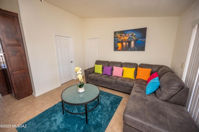 living room featuring light tile patterned floors and lofted ceiling