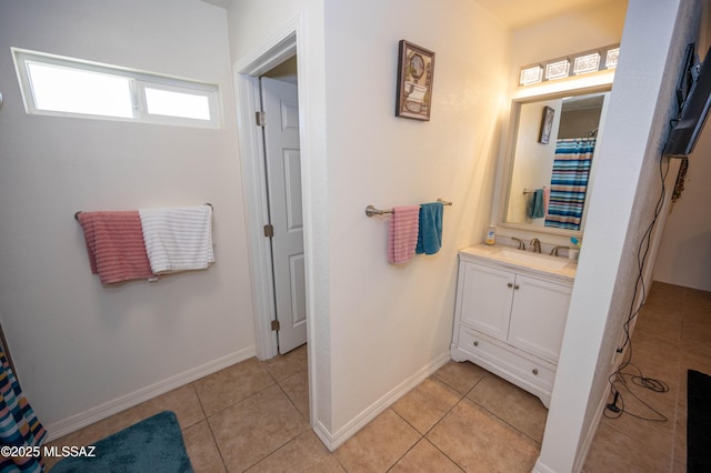 bathroom featuring baseboards, vanity, and tile patterned flooring