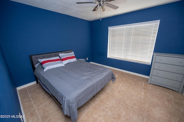 tiled bedroom featuring baseboards and ceiling fan