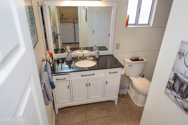 bathroom featuring vanity, tile patterned floors, toilet, and washing machine and dryer