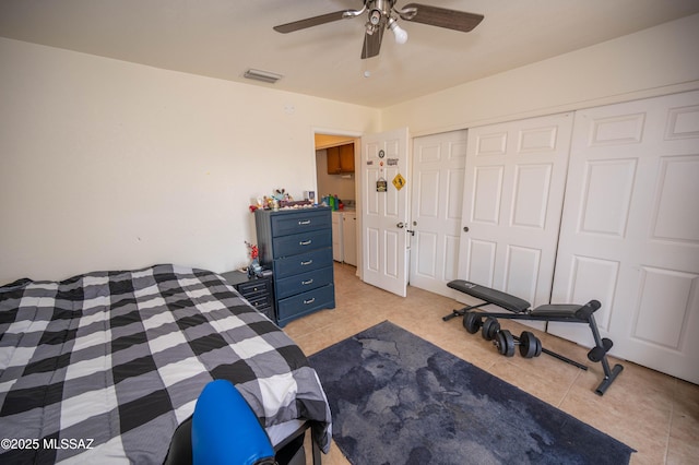 bedroom featuring visible vents, a closet, light tile patterned flooring, and a ceiling fan