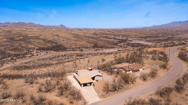aerial view featuring a mountain view and a desert view