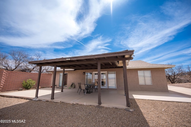 back of house featuring stucco siding, a patio area, and fence