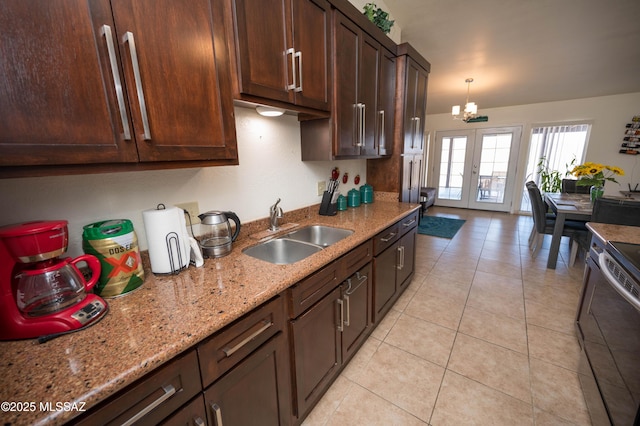 kitchen with electric range, a sink, an inviting chandelier, light tile patterned floors, and light stone countertops