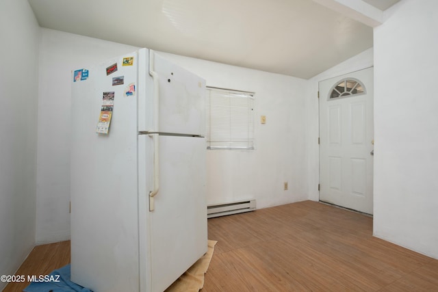 interior space with a baseboard radiator, lofted ceiling, and light wood-style floors