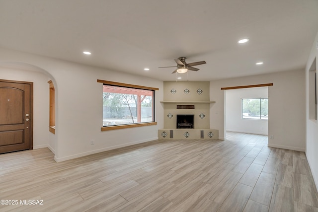 3053 W Lobo Rd, Tucson, AZ 85742 - unfurnished living room featuring recessed lighting, plenty of natural light, a ceiling fan, and light wood finished floors