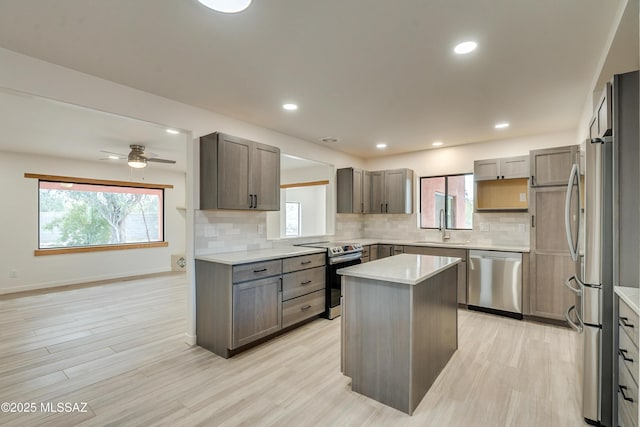 3053 W Lobo Rd, Tucson, AZ 85742 - kitchen featuring a sink, stainless steel appliances, plenty of natural light, and a kitchen island