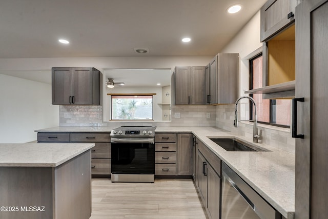 3053 W Lobo Rd, Tucson, AZ 85742 - kitchen featuring a sink, stainless steel appliances, light stone counters, and recessed lighting