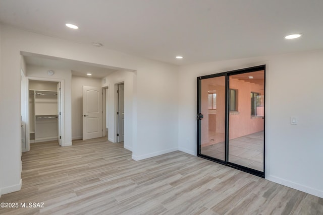 3053 W Lobo Rd, Tucson, AZ 85742 - empty room with light wood-style flooring, recessed lighting, and baseboards