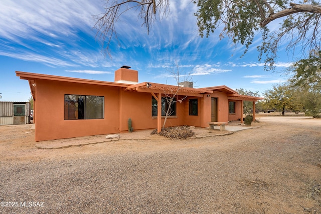 3053 W Lobo Rd, Tucson, AZ 85742 - rear view of property with stucco siding and a chimney