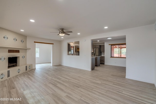 3053 W Lobo Rd, Tucson, AZ 85742 - unfurnished living room with recessed lighting, light wood-style floors, baseboards, and ceiling fan