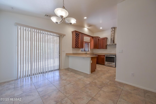 kitchen featuring visible vents, a peninsula, electric range, light countertops, and wall chimney range hood