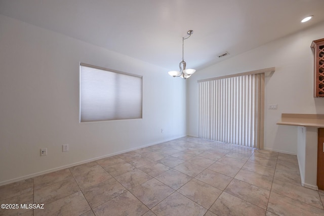 empty room with visible vents, baseboards, a chandelier, lofted ceiling, and light tile patterned floors