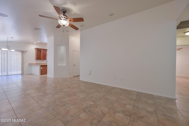 unfurnished living room featuring light tile patterned floors, visible vents, baseboards, and a ceiling fan