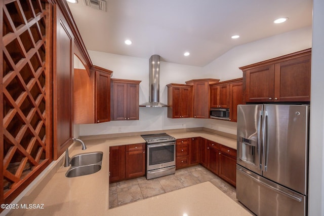 kitchen with visible vents, a sink, wall chimney range hood, stainless steel appliances, and light countertops
