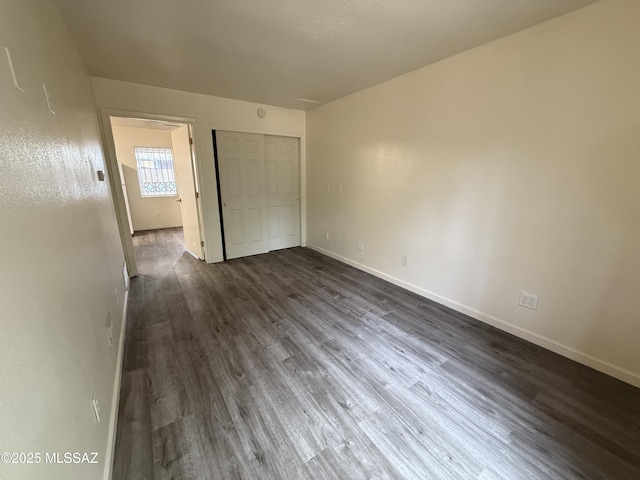 1419 E Linden St, Tucson, AZ 85719 - unfurnished bedroom with dark wood-type flooring and a closet