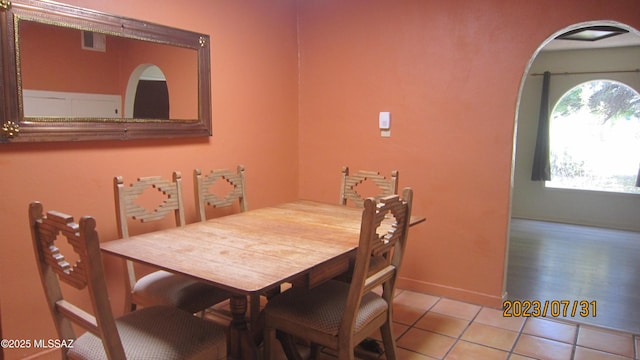 dining area with light tile patterned floors, visible vents, and a healthy amount of sunlight