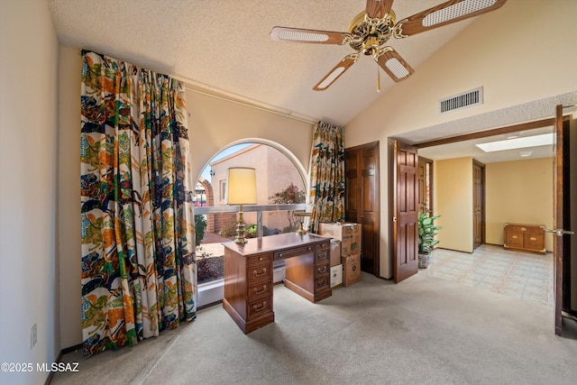 carpeted home office featuring visible vents, a textured ceiling, ceiling fan, and high vaulted ceiling