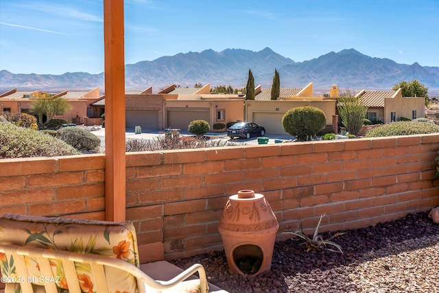 view of patio featuring an attached garage and a mountain view