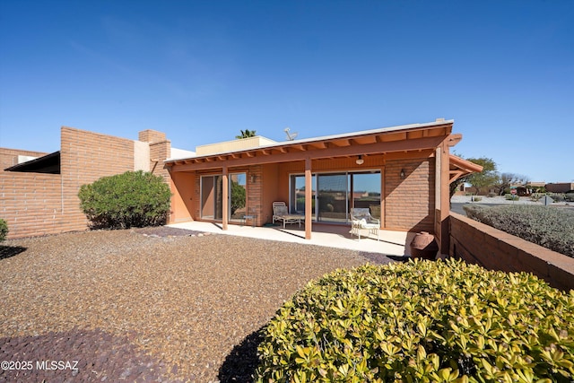 rear view of property featuring a patio area