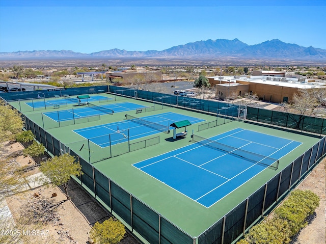 view of sport court featuring fence and a mountain view