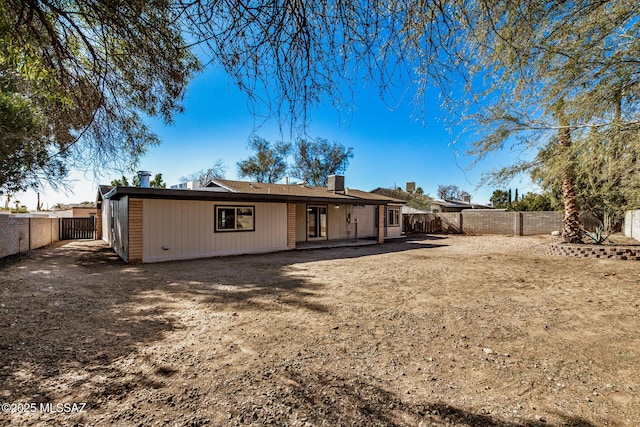 back of property with a patio and a fenced backyard