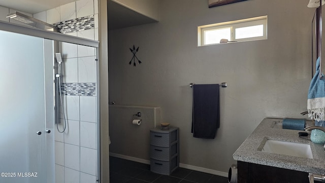 full bath featuring baseboards, a stall shower, tile patterned floors, and vanity