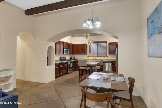 dining room featuring an inviting chandelier, arched walkways, beamed ceiling, and a high ceiling