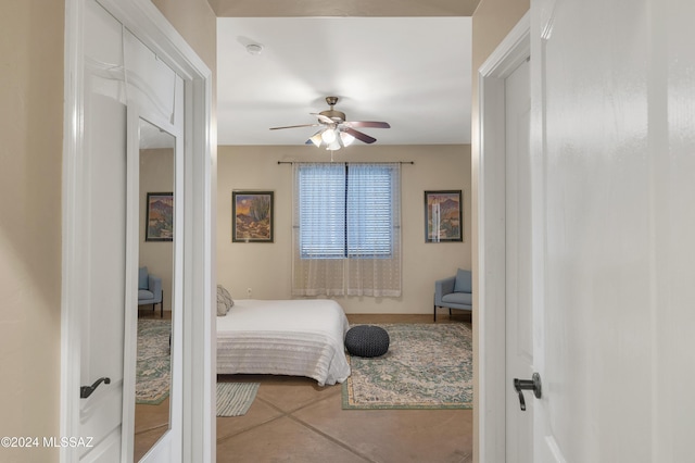 bedroom with ceiling fan and tile patterned flooring