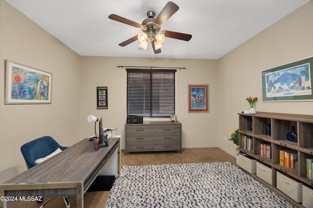 home office with light tile patterned floors and ceiling fan