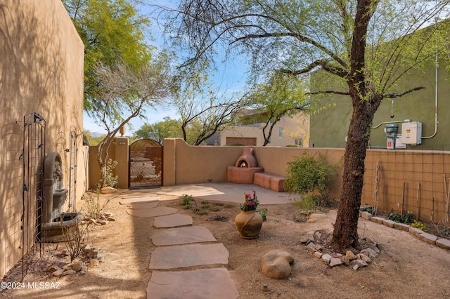 view of yard featuring a patio area, a gate, and fence