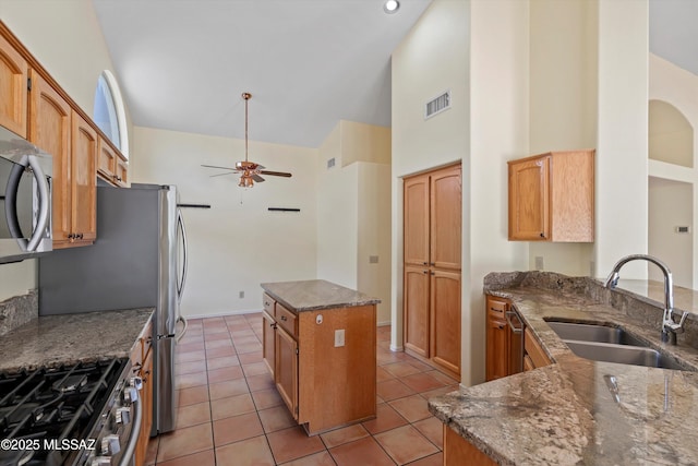 36973 S Highland Ridge Ct, Tucson, AZ 85739 - kitchen featuring a sink, stainless steel microwave, high vaulted ceiling, a ceiling fan, and dark stone counters